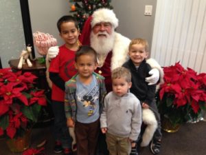 Justyn Martin, Ethan Stephenson, and brothers Milo and Sebastian McCormick meet Santa at the Carlsbad headquarters of Extraordinary Conceptions. Courtesy Photo