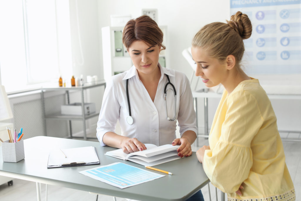 Patient having appointment with doctor in hospital