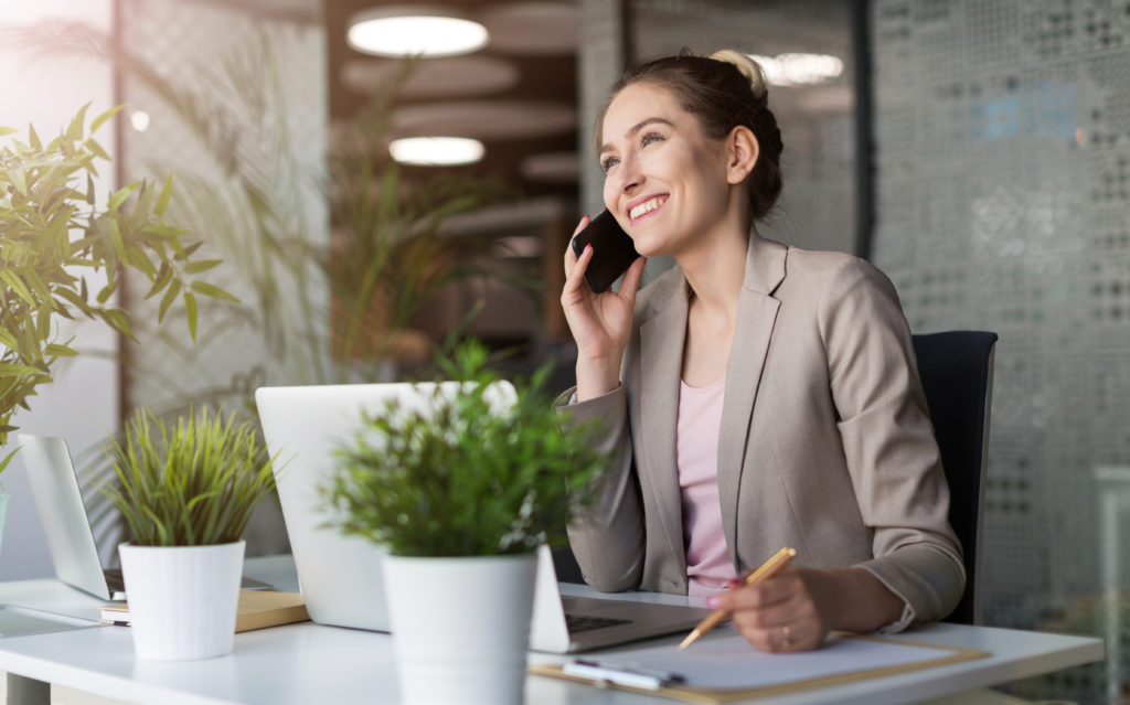 Young business woman working on laptop in office