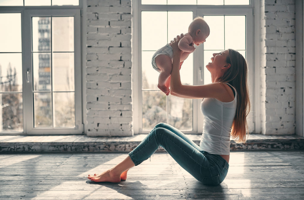 Young attractive mom with newborn