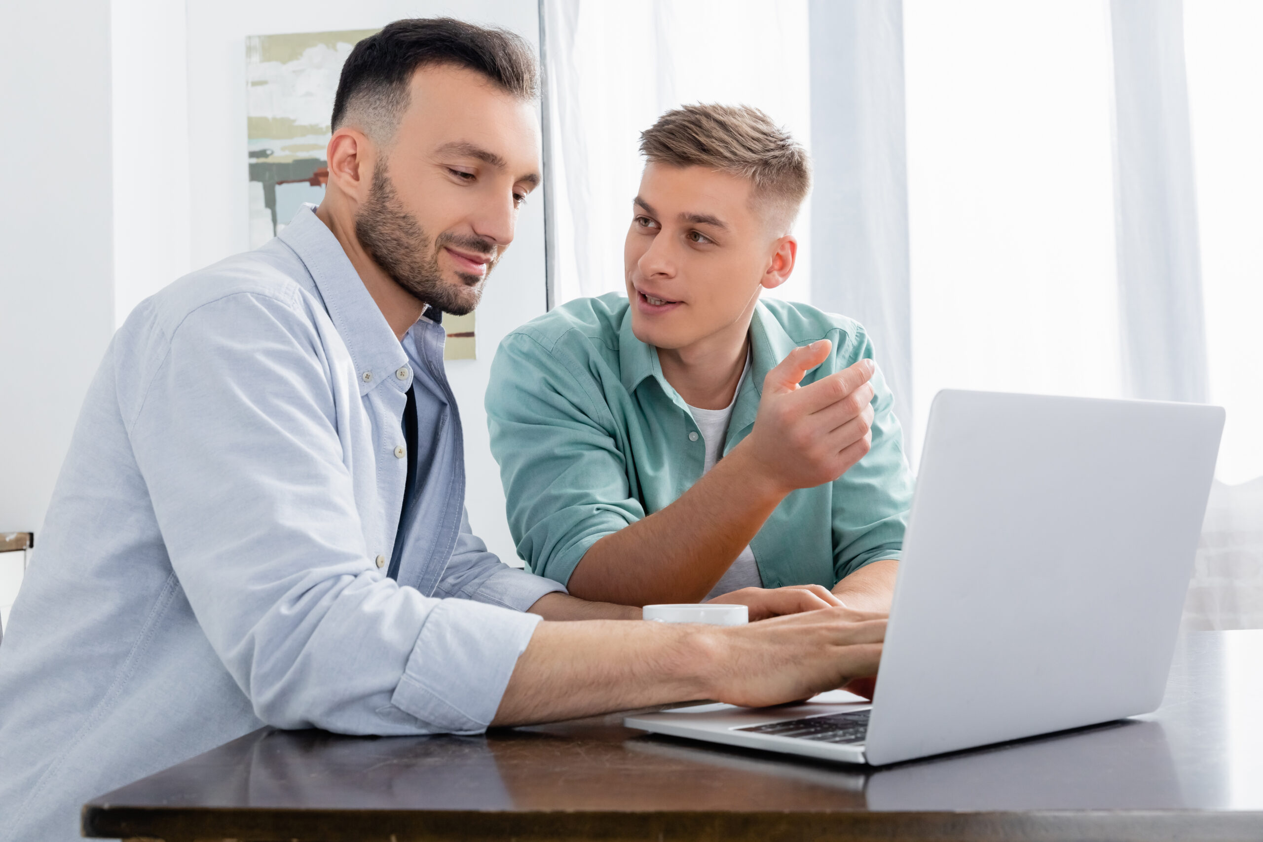 Partners researching on a laptop, possibly searching for an egg donor.